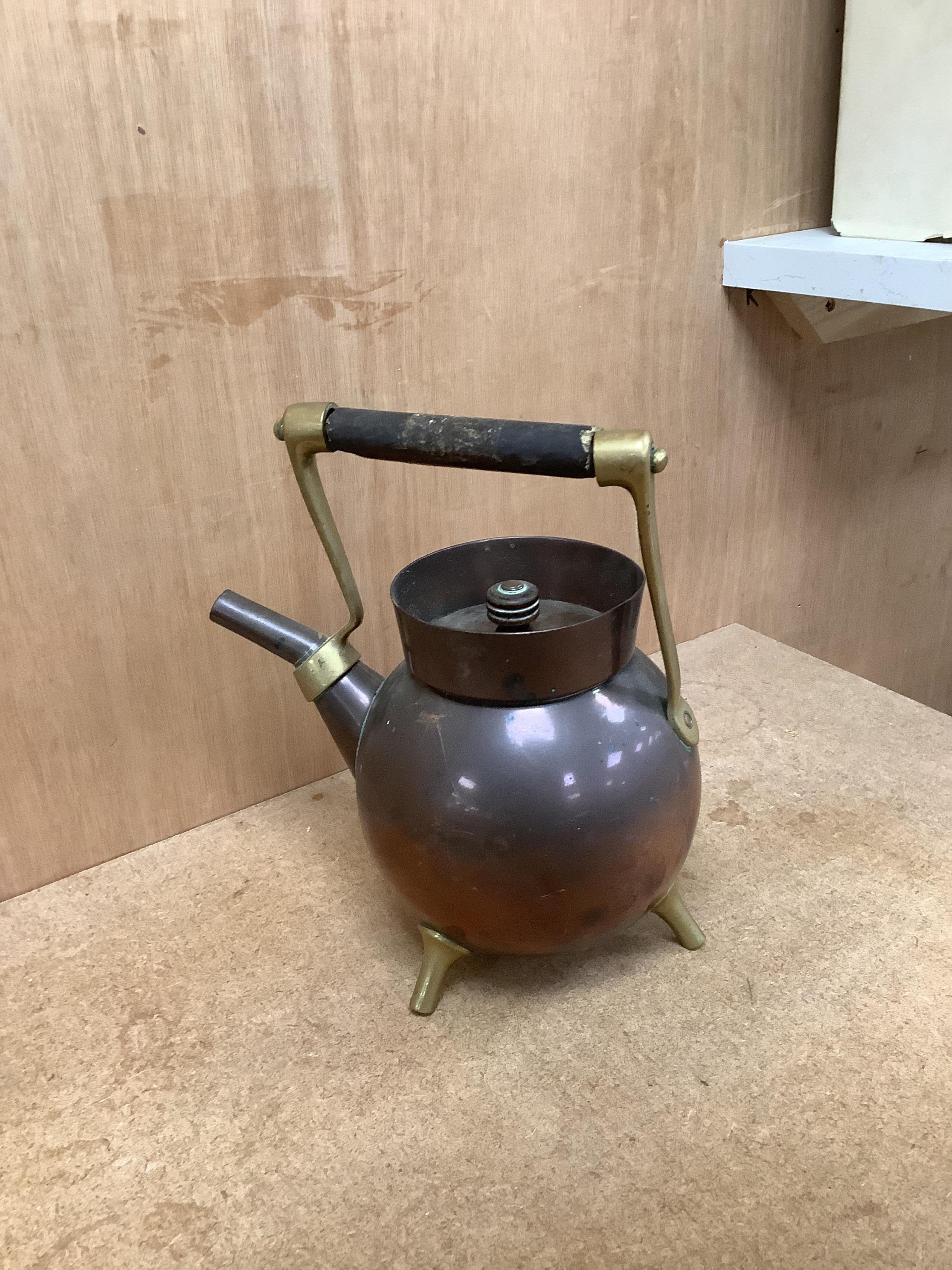 An Arts and crafts copper and brass Benham & Froud stamped Christopher Dresser teapot, (A.F), together with a two handle tray stamped Torini &Sons, Tray 49cm wide.